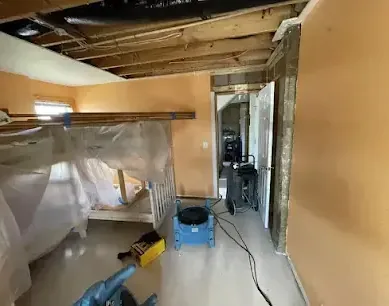 Containment plastic and drying equipment in a room with an opened ceiling